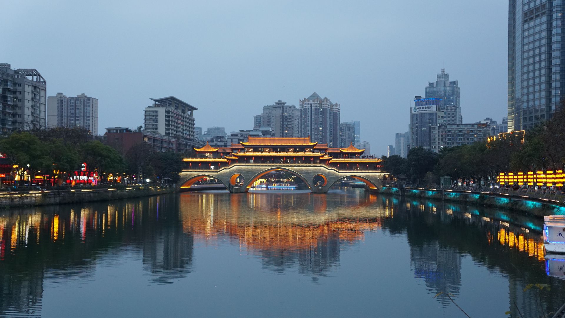Anshun Bridge illuminated above the river in Chengdu at dusk